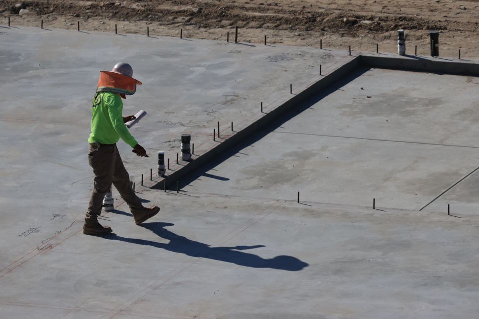 Concrete slab preparation shown for illustration; not a listed provider